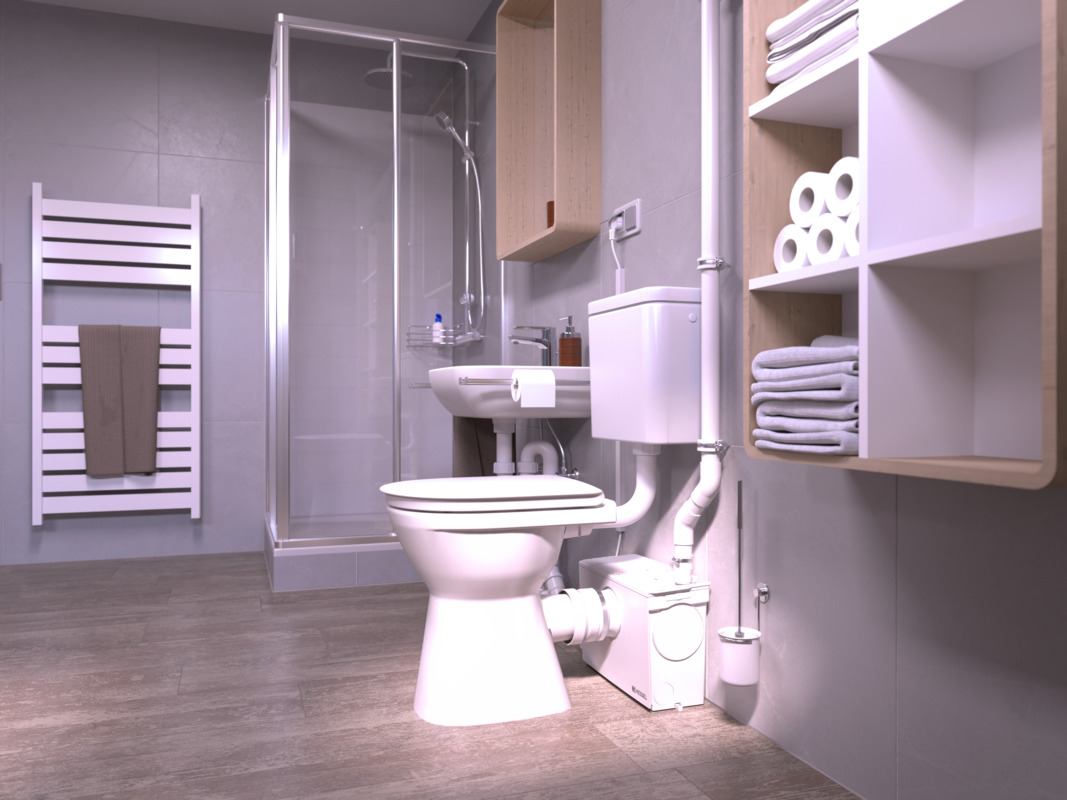 Close-up van een toilet, met daarachter een kleine opvoerinstallatie waarop ook een douche is aangesloten.